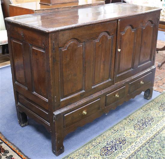 A mid 18th century oak chest, with panelled front and drawers beneath, formerly a mule chest W.144cm